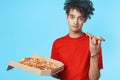 funny curly guy in a red t-shirt pizza delivery fast food snack Royalty Free Stock Photo