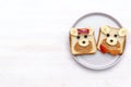 Funny cute bear,dog face sandwich toast bread with peanut butter, banana and apple. Kids childrens baby`s sweet dessert healthy Royalty Free Stock Photo