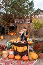 Funny cute boy at the counter selling pumpkins Royalty Free Stock Photo