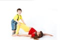 Funny cute brother and sister, girl and boy dressed in bright clothes, playing, hugging on a white background