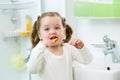 Funny cute child girl brushing teeth in bathroom Royalty Free Stock Photo