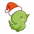 Funny and cute green little bird simling happily and wearing Santa`s hat for christmas Royalty Free Stock Photo