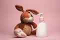 Funny and cute rabbit slob dirty looks at a bottle of soap shampoo or cream soap the importance of hygiene and hand