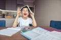 Funny cute smart Caucasian boy holding textbook above head. Having idea. Know solution.