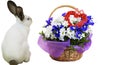 Funny cute white rabbit and a basket of wildflowers with a heart