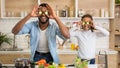 Funny daddy and daughter having fun while cooking lunch