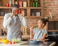 Funny daddy and daughter having good time at kitchen