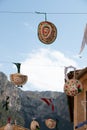 Funny decorated hats hanging from a thread on the street in a village festivals with mountains in the background