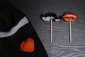Funny decorated heart shaped, candies lips, mustache on a sticks, red heart on white-black scarf, Valentine's day concept, styliz Royalty Free Stock Photo
