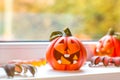 Funny decorative pumpkins for Halloween stand on the windowsill Royalty Free Stock Photo