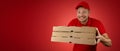 Funny delivery man with pizza boxes on red background. banner with copy space