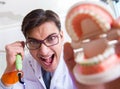 Funny dentist with curing light in medical concept Royalty Free Stock Photo