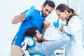 Funny dentist or dental surgeon acting crazy in front of his assistant Royalty Free Stock Photo