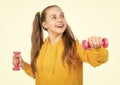 so funny. determination. happy teen girl with dumbbell. sport and fitness.