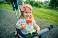 Funny with dirty lips.Baby girl with a lollipop in a big city, metropolis. A happy childhood, a sweet life. Summer Royalty Free Stock Photo