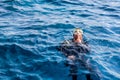 Diving instructor entertains tourists by fountains opening from