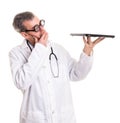 Funny Doctor Examines a laptop computer Royalty Free Stock Photo