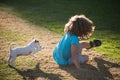 Funny doggy game. Child boy enjoying with her best friend dog. Kids playing with his pet dog. Royalty Free Stock Photo