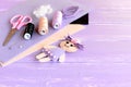 Funny doll decorated with buttons, thread set, needle, pins, scissors, flat pieces of felt on wooden background with blank place Royalty Free Stock Photo