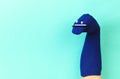 Funny doll sock on blue background, hand theater - Image Royalty Free Stock Photo
