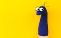 Funny doll sock on yelow background, hand theater - Image Royalty Free Stock Photo