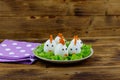 Funny easter breakfast with boiled eggs as chicks on wooden table Royalty Free Stock Photo