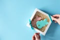 Funny Easter bunny shape cookies in gift box on blue background. Easter food tradition