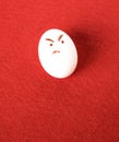 Funny easter emotion egg on red