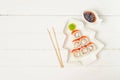 Funny edible Christmas tree made from sushi, creative idea for japanese restaurant on white background. New Year food background Royalty Free Stock Photo