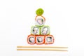 Funny edible Christmas tree made from sushi, creative idea for japanese restaurant on white background. New Year food Royalty Free Stock Photo