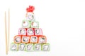 Funny edible Christmas tree made from sushi, creative idea for japanese restaurant on white background. New Year food Royalty Free Stock Photo