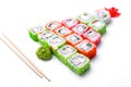 Funny edible Christmas tree made from sushi, creative idea for japanese restaurant on white background. New Year food