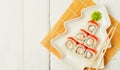 Funny edible Christmas tree made from sushi, creative idea for japanese restaurant on white background. New Year food background Royalty Free Stock Photo