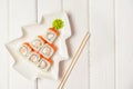 Funny edible Christmas tree made from sushi, creative idea for japanese restaurant on white background. New Year food background Royalty Free Stock Photo