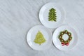 Funny edible Christmas tree an wreath, breakfast or snack idea for kids. Made of kiwi and grape. New Year, foodie, food concept.