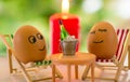 Funny eggs on a beach chair relaxing