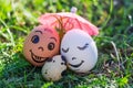 Funny eggs imitating smiling mixed couple with versicolored baby