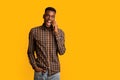 Funny Emotional Black Guy Talking On Cell Phone Over Yellow Background Royalty Free Stock Photo