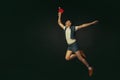 Young caucasian man playing tennis isolated on black studio background in retro style, action and motion concept