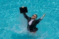 Funny excited businessman in suit with laptop in swimming pool. Crazy business man on summer vacation. Amazed Royalty Free Stock Photo