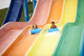 Funny excited child enjoying summer vacation in water park