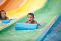 Funny excited child enjoying summer vacation in water park