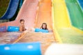 Funny excited child enjoying summer vacation in water park