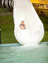 Funny excited child enjoying summer vacation in water park