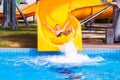Funny excited man enjoying summer vacation in water park riding yellow float Royalty Free Stock Photo