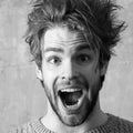Funny excited man with open Screaming nouth, close up. Young sexy man or handsome caucasian guy portrait Royalty Free Stock Photo