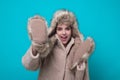 Funny excited Woman in winter warm hat and Winter gloves. Fun girl in woolen coat. Girl in winters cloth. Young woman in