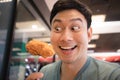 Funny face Asian man eat fried chicken Royalty Free Stock Photo