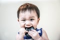 Funny Face Baby kid put thing in the mouth. Royalty Free Stock Photo