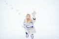 Funny face. Beautiful happy laughing young woman wearing winter hat gloves and scarf covered with snow flakes. Winter Royalty Free Stock Photo